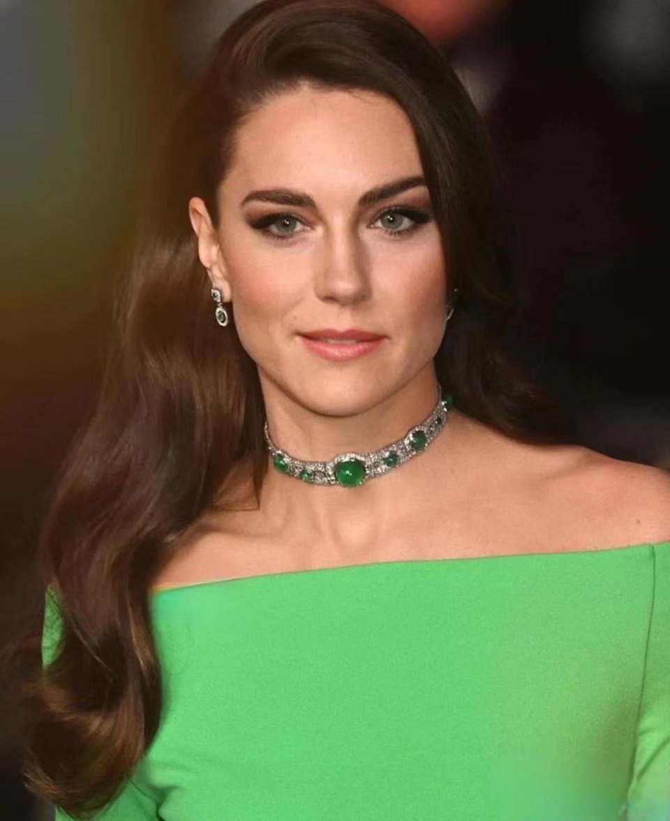 Kate Middleton wears her hair sleek to showcase the emerald choker.