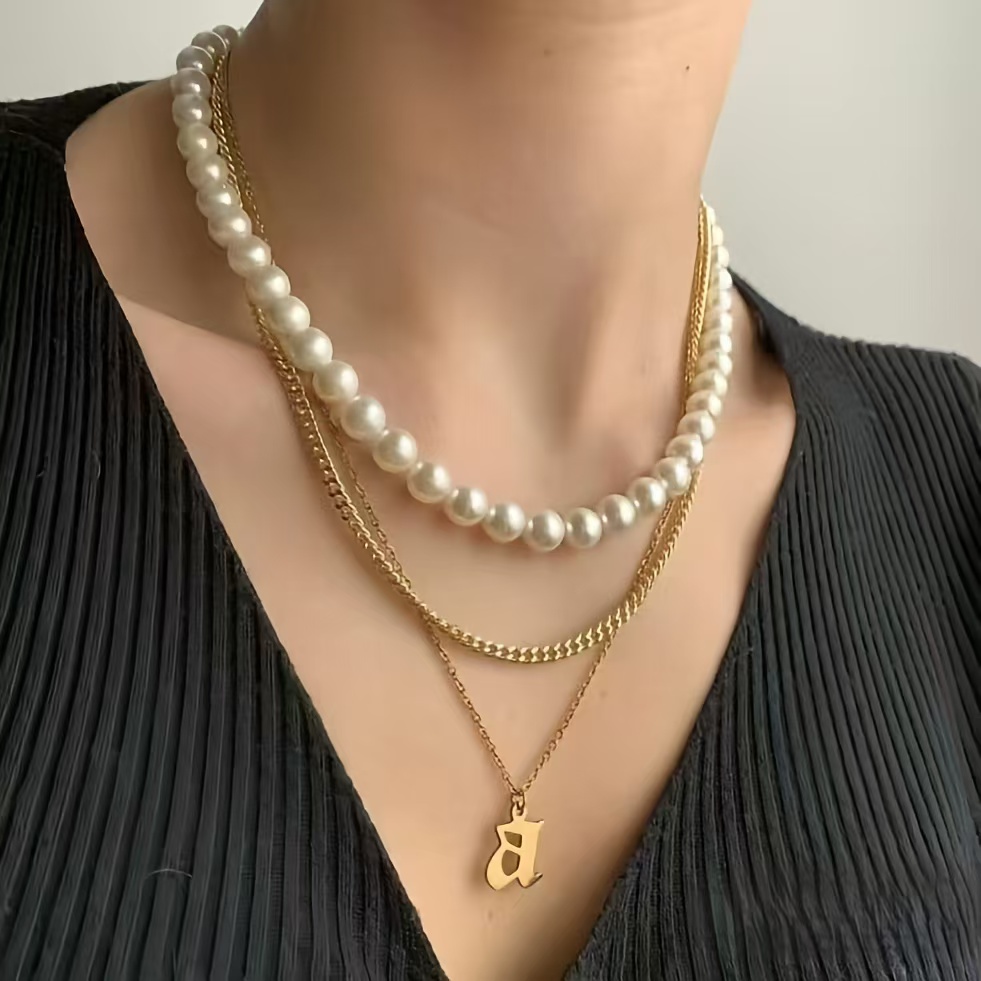 Simple fine chain necklace and it the most delicate way styled with a deep V-shape neck sweater for this elegant winter fashion look.