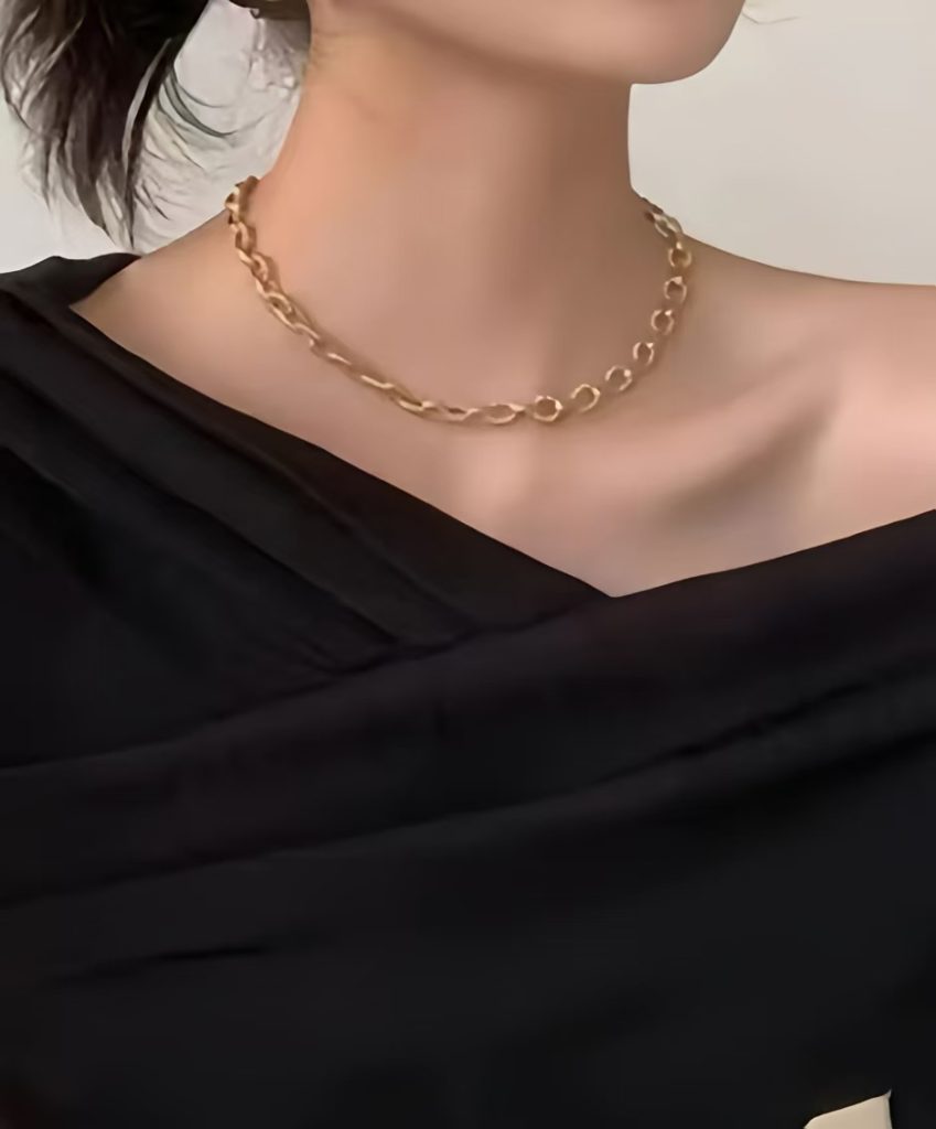 For an effortlessly elegant winter look, slip on an off-the-shoulder design and a chic choker necklace.